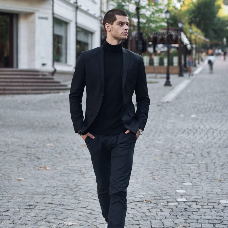 Young man walking, smart casual on an autumn day on a street of European City. Lifestyle Photography